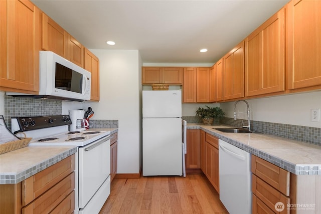 7717 176th Ave SW, Longbranch, WA 98351 - kitchen featuring white appliances, light wood-style floors, backsplash, recessed lighting, and light countertops