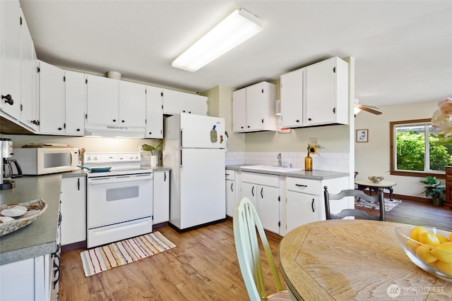 7717 176th Ave SW, Longbranch, WA 98351 - kitchen with white appliances, under cabinet range hood, and light wood-style floors