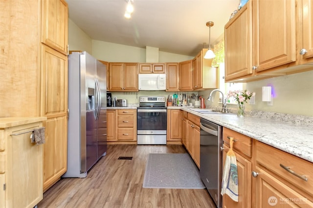 2101 S 324th St Unit 22, Federal Way, WA 98003 - kitchen featuring appliances with stainless steel finishes, light wood finished floors, lofted ceiling, pendant lighting, and light brown cabinetry