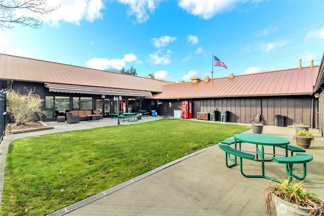 2101 S 324th St Unit 22, Federal Way, WA 98003 - back of property with outdoor lounge area, a yard, a metal roof, a patio area, and board and batten siding