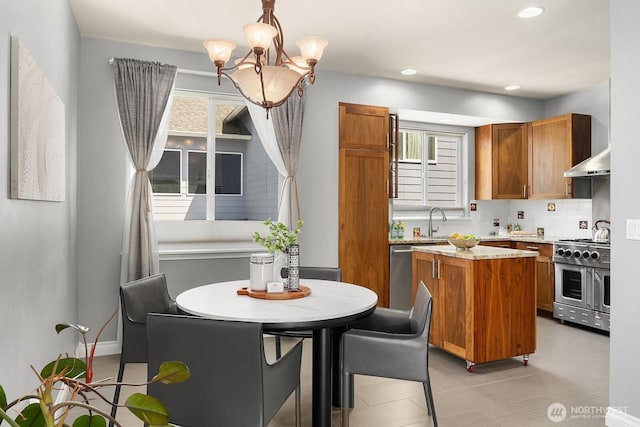 10113 SE 220th Pl, Kent, WA 98031 - kitchen featuring appliances with stainless steel finishes, brown cabinets, healthy amount of natural light, a kitchen island, and recessed lighting