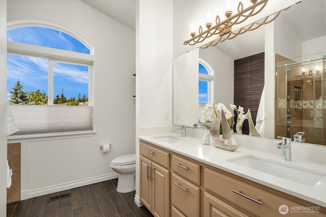 10113 SE 220th Pl, Kent, WA 98031 - full bath featuring double vanity, a shower stall, and wood tiled floors