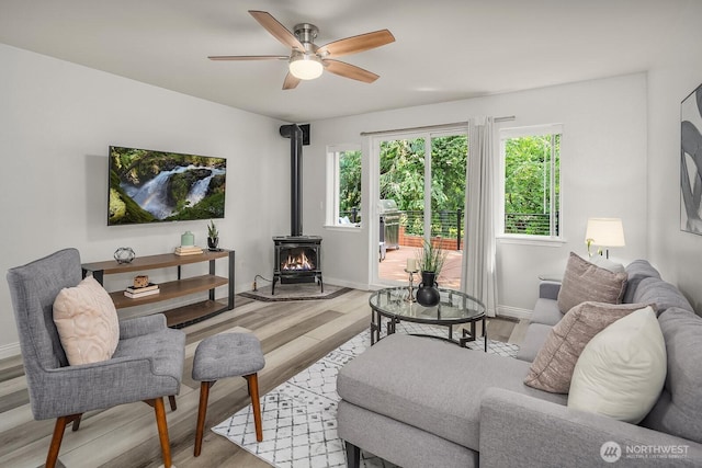 10113 SE 220th Pl, Kent, WA 98031 - living room with a wood stove, ceiling fan, and light wood-type flooring