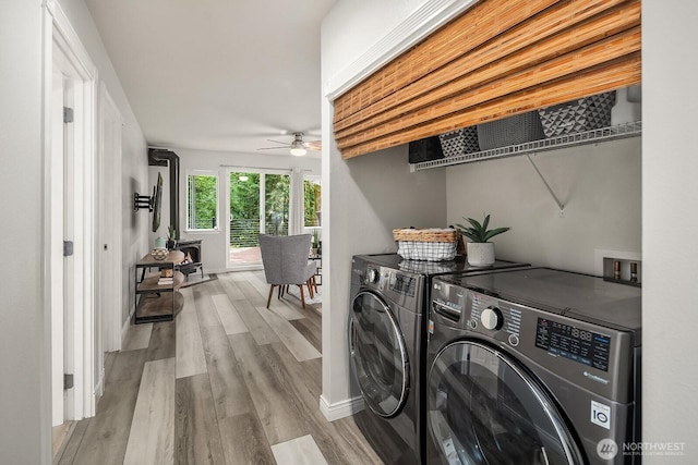 10113 SE 220th Pl, Kent, WA 98031 - laundry room with washing machine and dryer, a ceiling fan, and wood finished floors