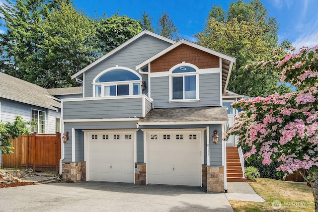 10113 SE 220th Pl, Kent, WA 98031 - view of front of property with driveway, stone siding, a garage, and stairway