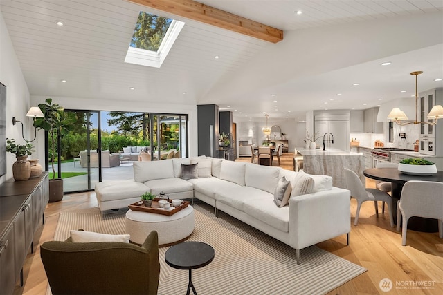 2610 86th Ave NE, Clyde Hill, WA 98004 - living room with recessed lighting, light wood finished floors, a skylight, and a chandelier