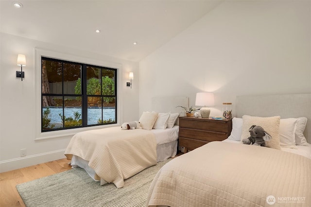 2610 86th Ave NE, Clyde Hill, WA 98004 - bedroom with light wood-style flooring, vaulted ceiling, and recessed lighting