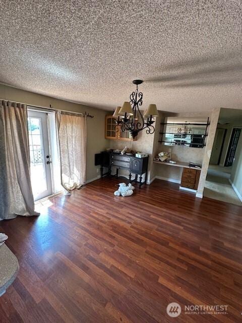 129 W Washington St, Napavine, WA 98565 - unfurnished dining area featuring a textured ceiling, a chandelier, and wood finished floors