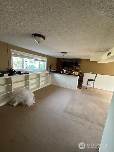 129 W Washington St, Napavine, WA 98565 - basement with carpet, a textured ceiling, and a fireplace