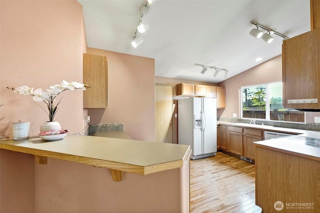 8506 8th Ct SE, Olympia, WA 98513 - kitchen with track lighting, white refrigerator with ice dispenser, a peninsula, light wood-style floors, and lofted ceiling