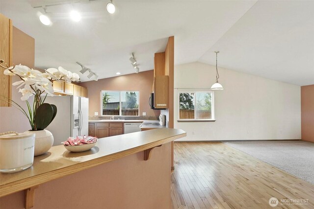 8506 8th Ct SE, Olympia, WA 98513 - kitchen with track lighting, white appliances, lofted ceiling, pendant lighting, and light countertops