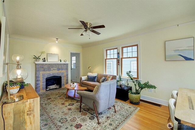 752 N 84th, Seattle, WA 98103 - living room with ceiling fan, ornamental molding, a tile fireplace, and wood finished floors