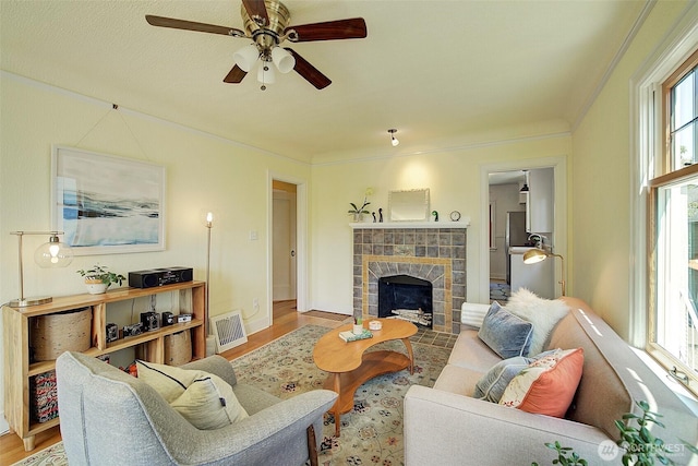 752 N 84th, Seattle, WA 98103 - living room with wood finished floors, ceiling fan, and a tiled fireplace