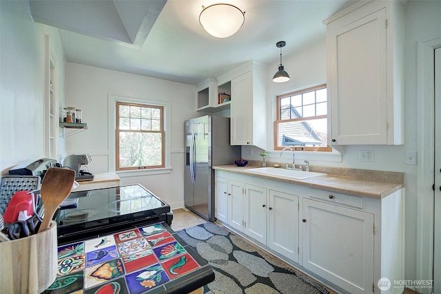 752 N 84th, Seattle, WA 98103 - kitchen with stainless steel refrigerator with ice dispenser, light countertops, white cabinets, and plenty of natural light