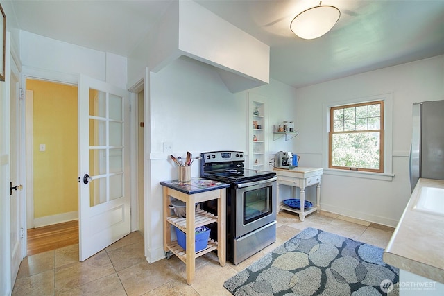 752 N 84th, Seattle, WA 98103 - kitchen featuring appliances with stainless steel finishes, light tile patterned flooring, and light countertops