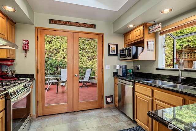 7139 Wright Ave SW, Seattle, WA 98136 - kitchen with appliances with stainless steel finishes, recessed lighting, french doors, dark stone counters, and brown cabinets
