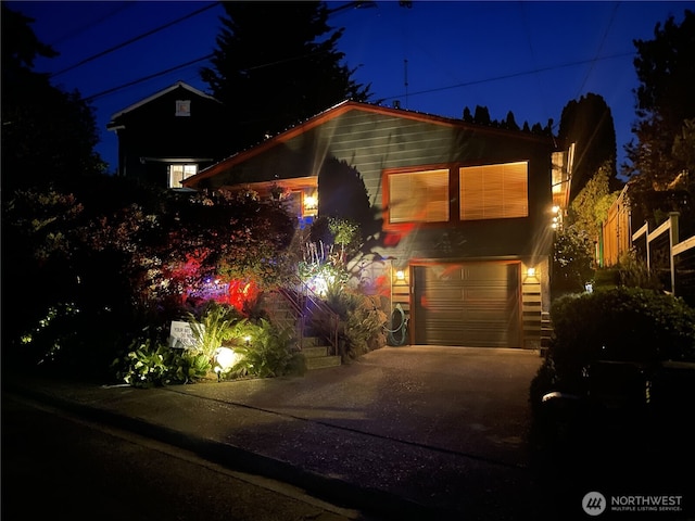 7139 Wright Ave SW, Seattle, WA 98136 - view of front facade featuring driveway and a garage