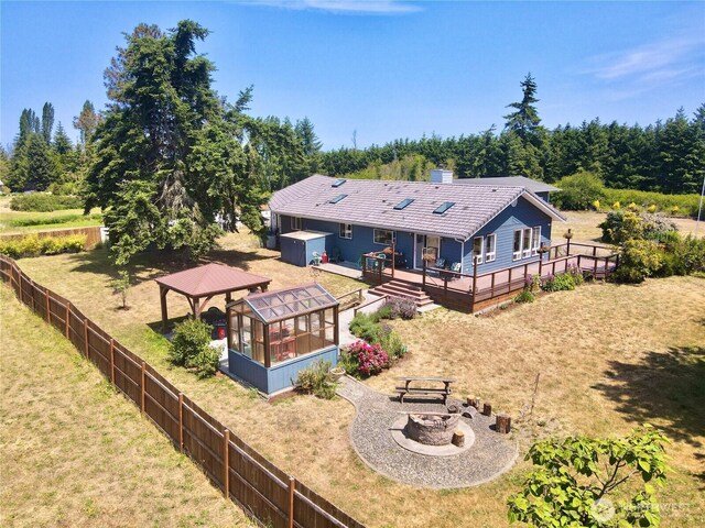 10 Davenhill Ln, Sequim, WA 98382 - rear view of house featuring an outdoor fire pit, a gazebo, a wooden deck, a chimney, and a tile roof