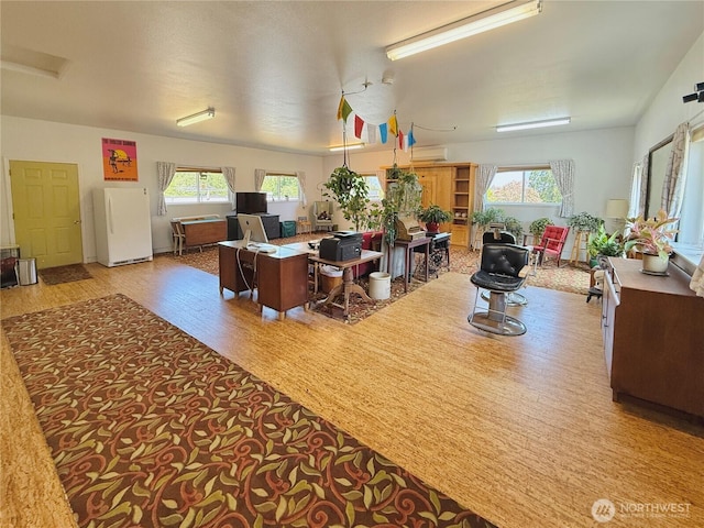 10 Davenhill Ln, Sequim, WA 98382 - office area with plenty of natural light, wood finished floors, and a wall mounted air conditioner