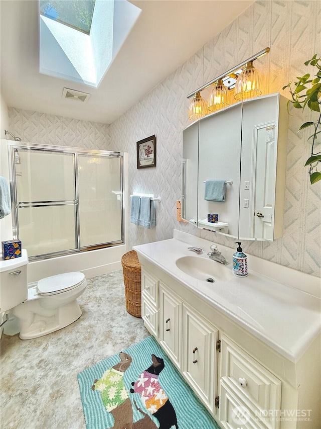 10 Davenhill Ln, Sequim, WA 98382 - full bathroom featuring a skylight, vanity, and enclosed tub / shower combo