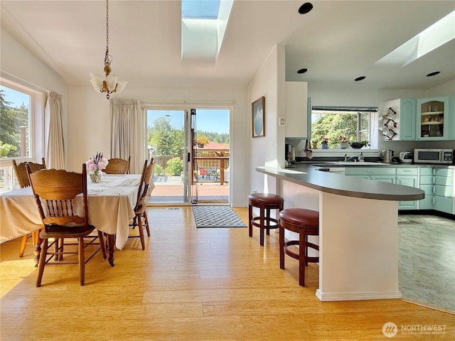 10 Davenhill Ln, Sequim, WA 98382 - dining room featuring a chandelier, light wood-style flooring, and a skylight