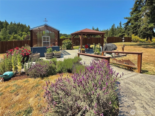 10 Davenhill Ln, Sequim, WA 98382 - fenced backyard with a gazebo, a greenhouse, an outdoor structure, and a patio