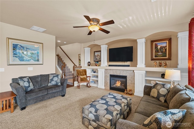 5539 Charlotte Ave SE, Auburn, WA 98092 - living area featuring carpet, ornate columns, stairs, a ceiling fan, and a tile fireplace
