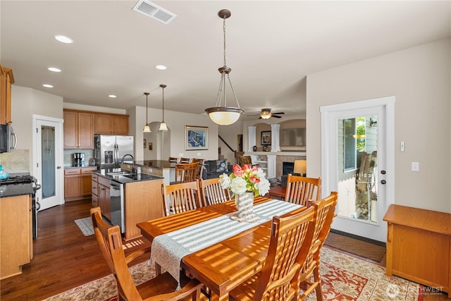 5539 Charlotte Ave SE, Auburn, WA 98092 - dining space with dark wood-style floors, a ceiling fan, recessed lighting, and a tile fireplace