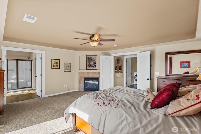 5539 Charlotte Ave SE, Auburn, WA 98092 - bedroom with carpet floors, washer / dryer, a fireplace, a raised ceiling, and a ceiling fan