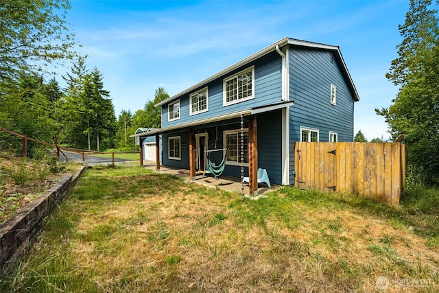 210 E Mossflower Ln, Grapeview, WA 98546 - rear view of house with a garage and a patio