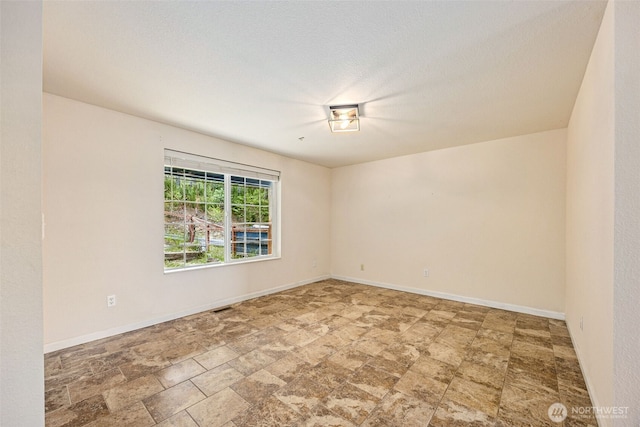 210 E Mossflower Ln, Grapeview, WA 98546 - empty room with stone finish floors and baseboards