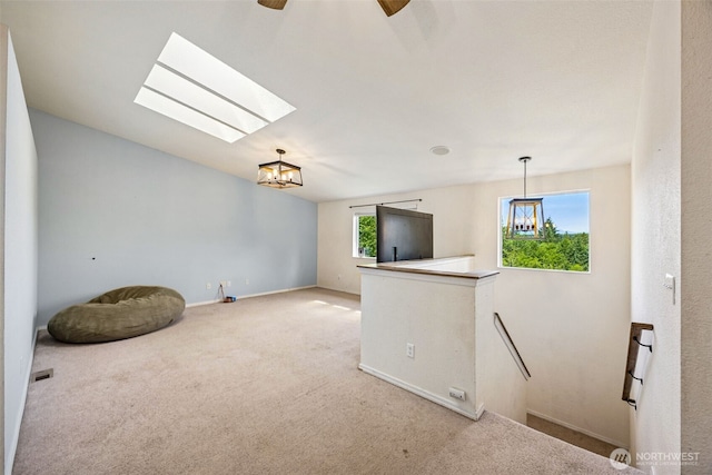 210 E Mossflower Ln, Grapeview, WA 98546 - carpeted empty room featuring a chandelier, a skylight, and a ceiling fan