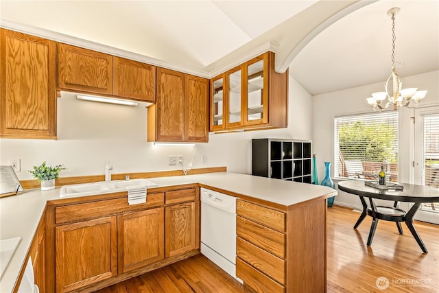 8221 53rd Ave W Unit 15C, Mukilteo, WA 98275 - kitchen with white dishwasher, lofted ceiling, a peninsula, light wood-style floors, and light countertops