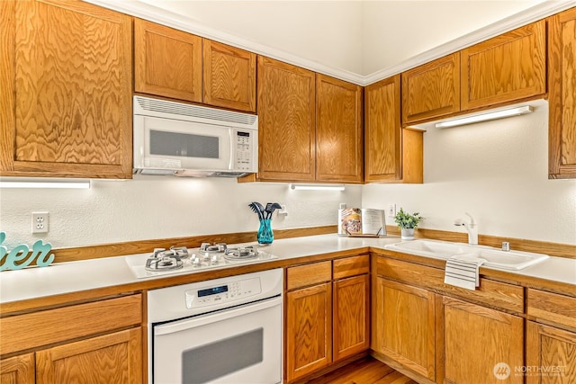 8221 53rd Ave W Unit 15C, Mukilteo, WA 98275 - kitchen featuring white appliances, light countertops, and brown cabinets