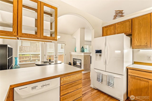 8221 53rd Ave W Unit 15C, Mukilteo, WA 98275 - kitchen with white appliances, light wood finished floors, light countertops, a fireplace, and vaulted ceiling
