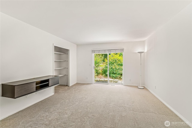 8221 53rd Ave W Unit 15C, Mukilteo, WA 98275 - unfurnished living room with carpet flooring and built in shelves
