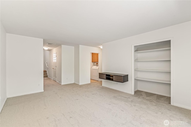 8221 53rd Ave W Unit 15C, Mukilteo, WA 98275 - unfurnished living room featuring washer / dryer and light colored carpet