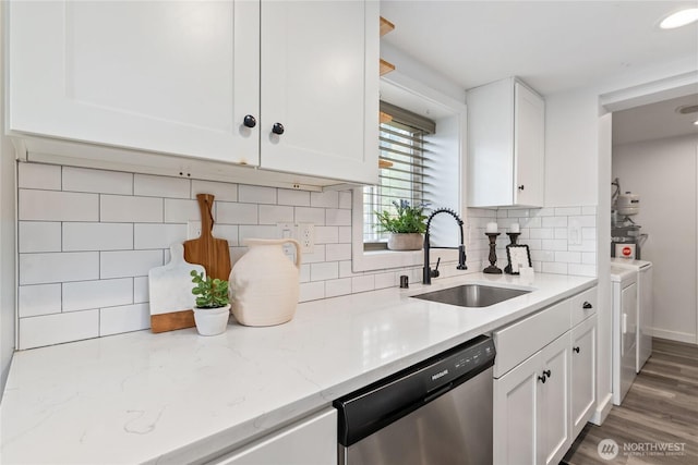 1902 72nd St E, Tacoma, WA 98404 - kitchen with stainless steel dishwasher, white cabinets, independent washer and dryer, and backsplash