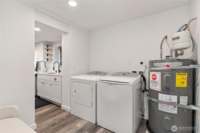 1902 72nd St E, Tacoma, WA 98404 - washroom featuring secured water heater, washer and dryer, light wood-style floors, and recessed lighting