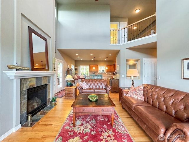 453 Louella Heights Dr, Sequim, WA 98382 - living room featuring light wood-style floors, a high ceiling, a tile fireplace, and recessed lighting