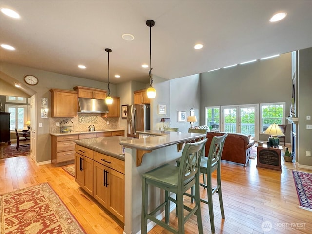453 Louella Heights Dr, Sequim, WA 98382 - kitchen featuring stainless steel fridge, ventilation hood, light wood-type flooring, healthy amount of natural light, and recessed lighting