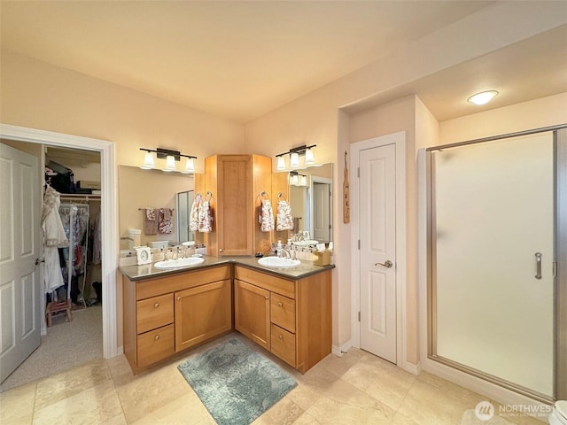 453 Louella Heights Dr, Sequim, WA 98382 - bathroom with a shower stall, double vanity, a walk in closet, and tile patterned floors