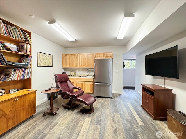 453 Louella Heights Dr, Sequim, WA 98382 - kitchen with freestanding refrigerator, light wood finished floors, light countertops, and light brown cabinets