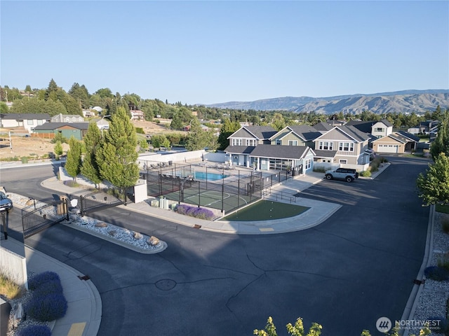 2452 NW Columbia Ave Unit 34, East Wenatchee, WA 98802 - aerial perspective of suburban area with a pool area and mountains