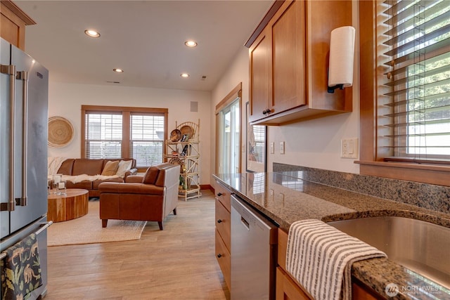 2452 NW Columbia Ave Unit 34, East Wenatchee, WA 98802 - kitchen with appliances with stainless steel finishes, recessed lighting, light wood-style flooring, brown cabinetry, and open floor plan