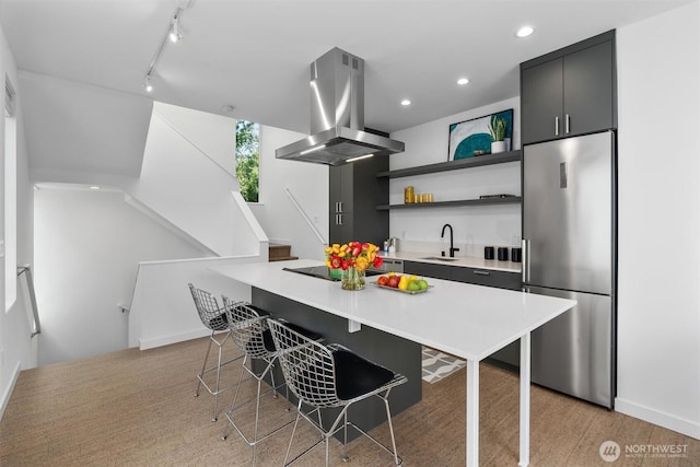 3642A Interlake Ave N, Seattle, WA 98103 - kitchen featuring island exhaust hood, stainless steel fridge, open shelves, light countertops, and a breakfast bar area