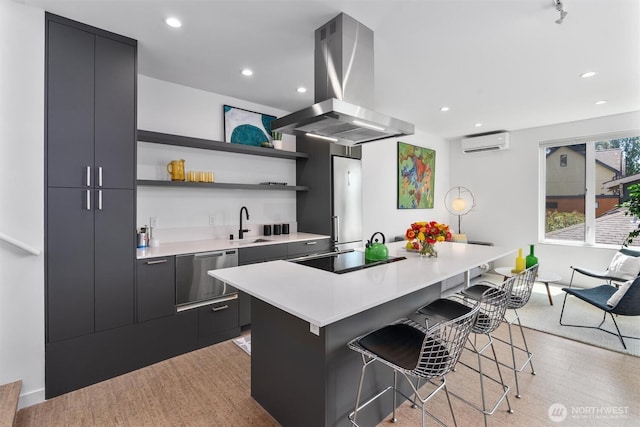 3642A Interlake Ave N, Seattle, WA 98103 - kitchen featuring island range hood, a wall mounted AC, dishwasher, black electric cooktop, and a breakfast bar