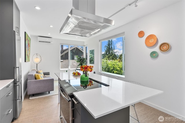 3642A Interlake Ave N, Seattle, WA 98103 - kitchen with an AC wall unit, range with electric cooktop, wall chimney exhaust hood, light countertops, and modern cabinets