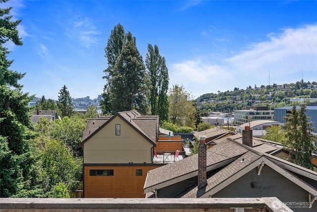 3642A Interlake Ave N, Seattle, WA 98103 - exterior space featuring a shingled roof and a chimney