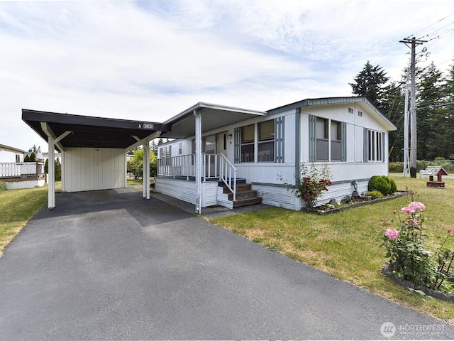 20725 9th Ave E Unit 6, Spanaway, WA 98387 - manufactured / mobile home with a front yard, asphalt driveway, and a carport